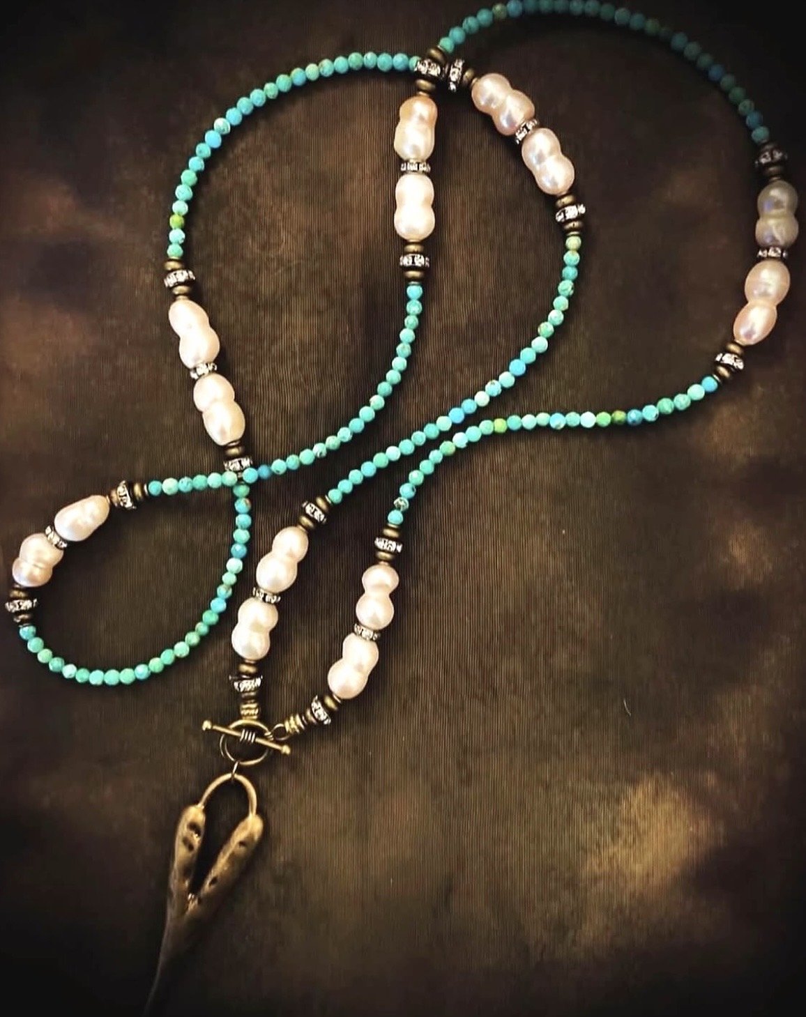 Turquoise and pearl lovebeads with a horn charm