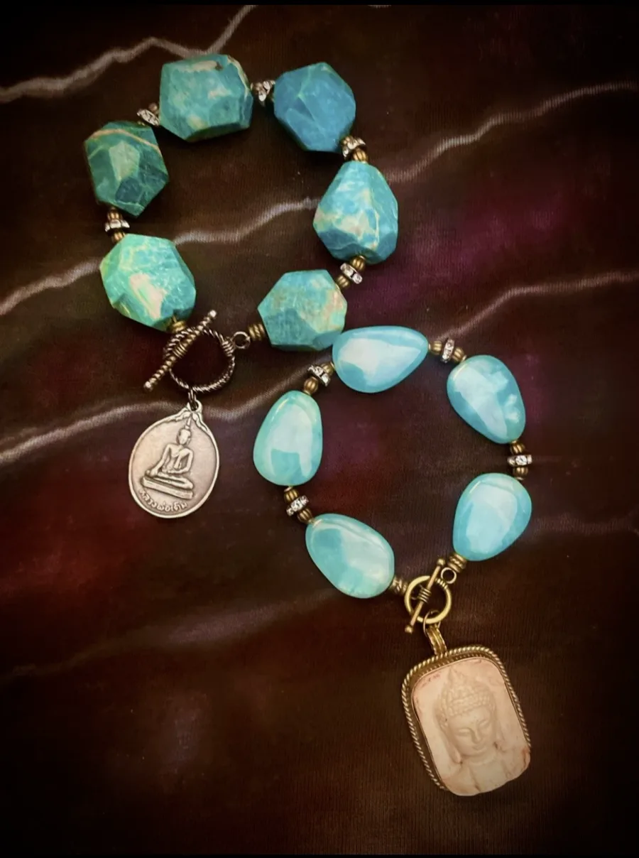Turquoise gemstone Buddha lovebeads on dark fabric