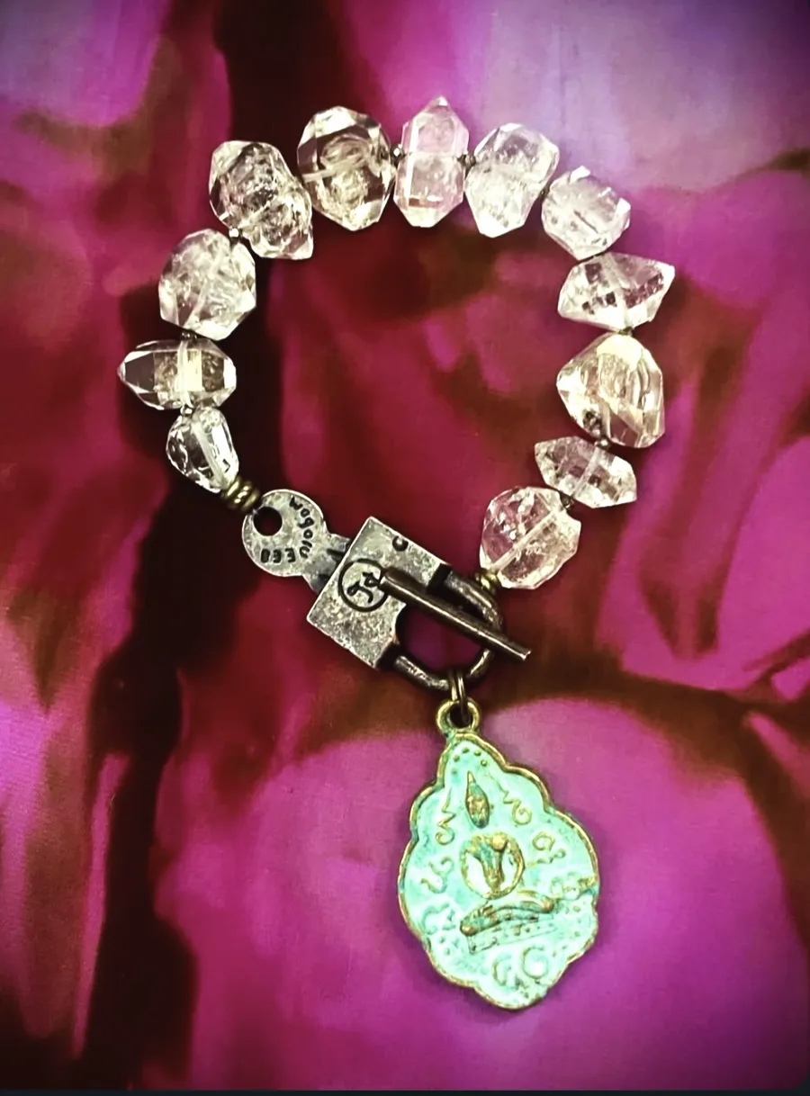 Clear crystal bracelet with a turquoise Buddha pendant